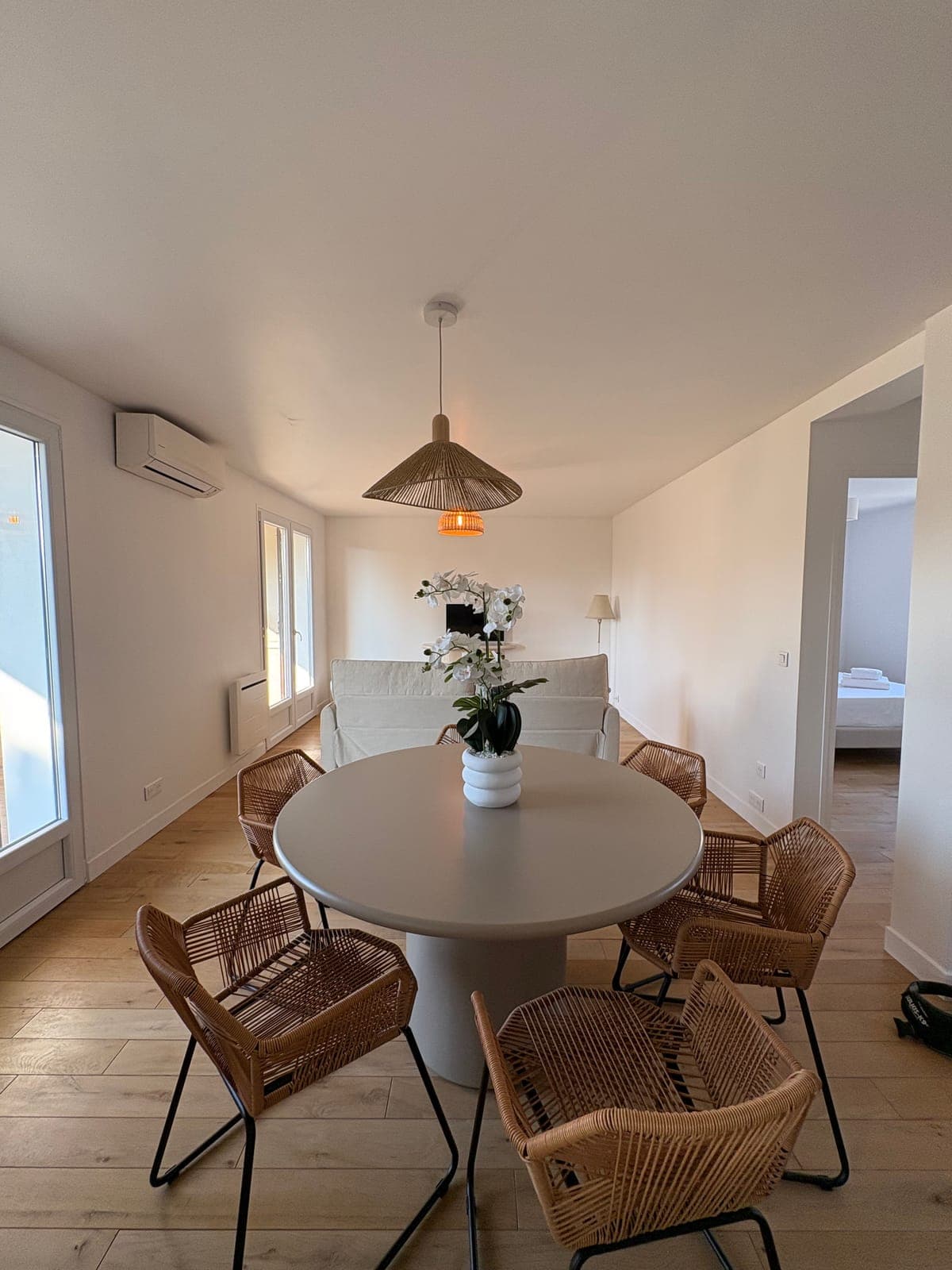 The dining corner of the second apartment, with its sculptural pendant — Sanary-sur-Mer — two apartment furnishing project